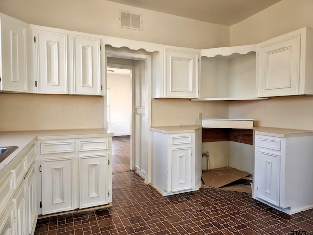 501 E Park Ave, Palestine, TX 75801 - kitchen with white cabinetry, light countertops, and baseboards