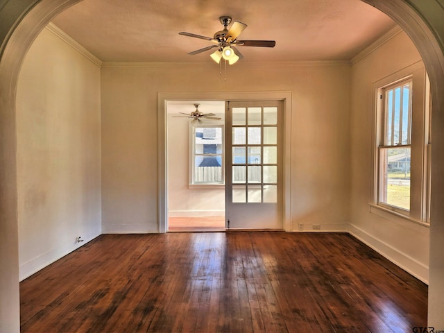501 E Park Ave, Palestine, TX 75801 - spare room with arched walkways, dark wood-style floors, ceiling fan, ornamental molding, and baseboards