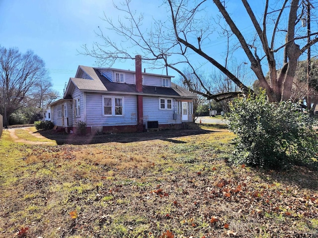 501 E Park Ave, Palestine, TX 75801 - back of property with a chimney, central AC unit, and entry steps