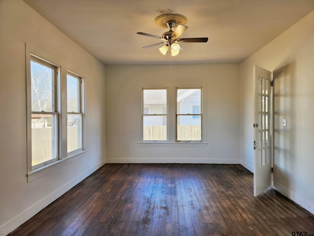 501 E Park Ave, Palestine, TX 75801 - spare room with dark wood finished floors, baseboards, and a ceiling fan