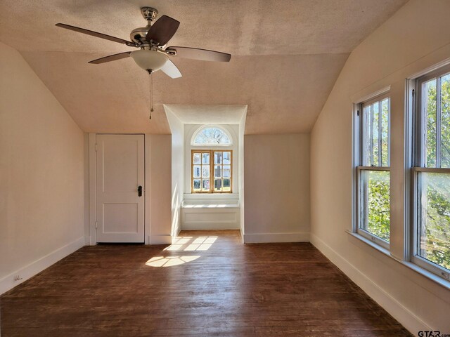 501 E Park Ave, Palestine, TX 75801 - unfurnished room featuring lofted ceiling, dark wood-style floors, baseboards, a textured ceiling, and ceiling fan