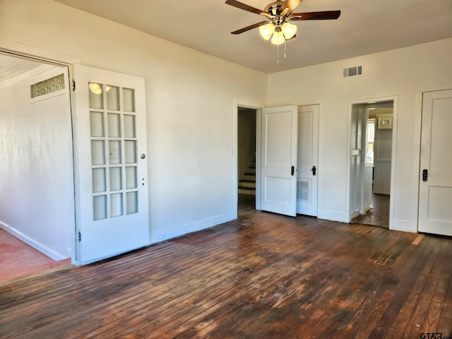 501 E Park Ave, Palestine, TX 75801 - unfurnished bedroom with dark wood-style flooring, baseboards, and a ceiling fan