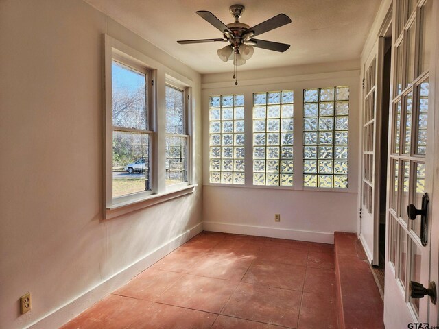 501 E Park Ave, Palestine, TX 75801 - unfurnished sunroom featuring baseboards and tile patterned flooring