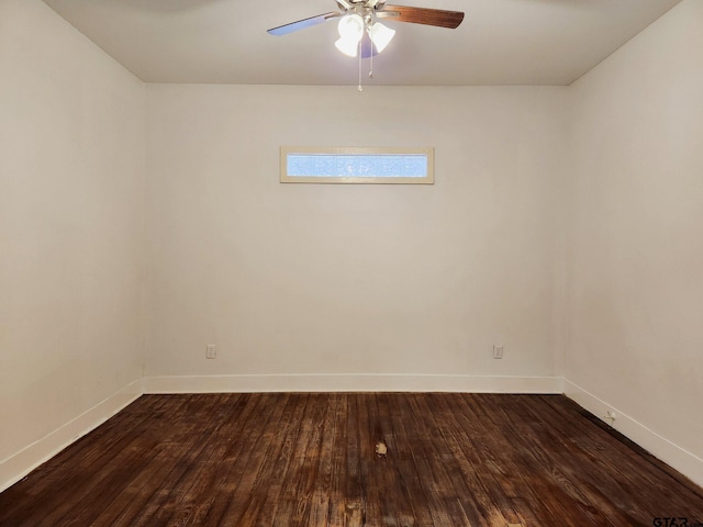 spare room featuring dark wood-type flooring and ceiling fan