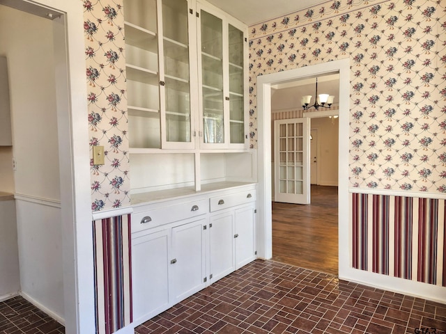 501 E Park Ave, Palestine, TX 75801 - bar with wallpapered walls, brick patterned floors, a chandelier, and baseboards