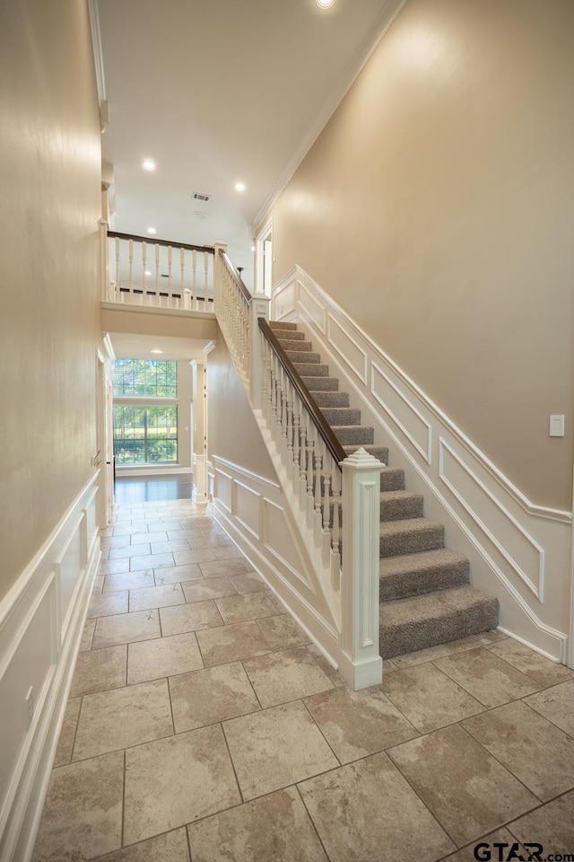 409 Rosebrook Cir, Whitehouse, TX 75791 - staircase with a decorative wall, stone tile floors, recessed lighting, a wainscoted wall, and ornamental molding