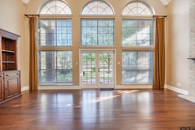 409 Rosebrook Cir, Whitehouse, TX 75791 - entryway featuring a towering ceiling, dark wood-type flooring, a fireplace, and french doors