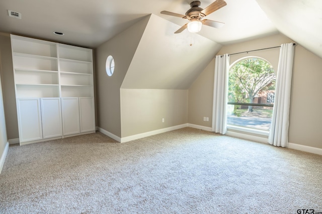 bonus room with light carpet, ceiling fan, and lofted ceiling