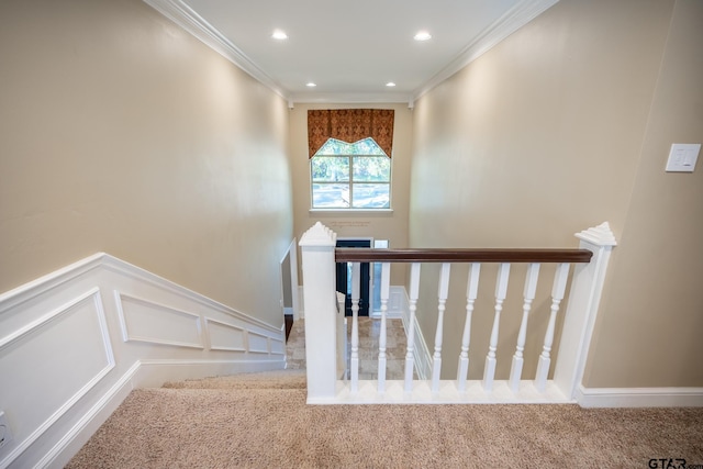 staircase with carpet and ornamental molding