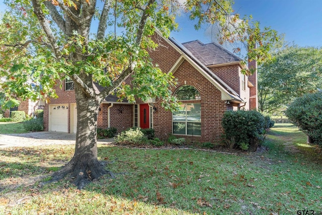 view of property with a garage and a front lawn