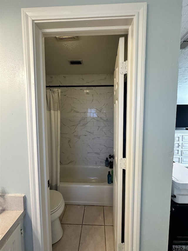 full bathroom featuring tile patterned floors, vanity, toilet, and shower / bath combo