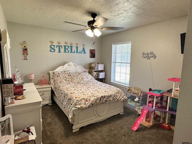 bedroom with a textured ceiling, ceiling fan, and dark colored carpet