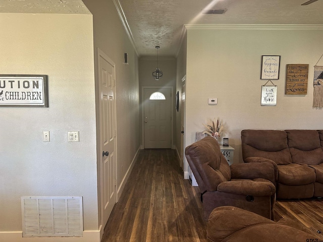 hallway with dark hardwood / wood-style flooring, crown molding, and a textured ceiling