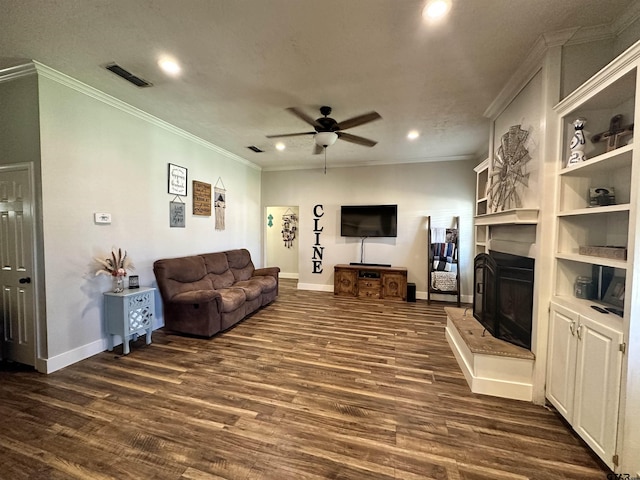 living room with crown molding, dark wood-type flooring, and ceiling fan