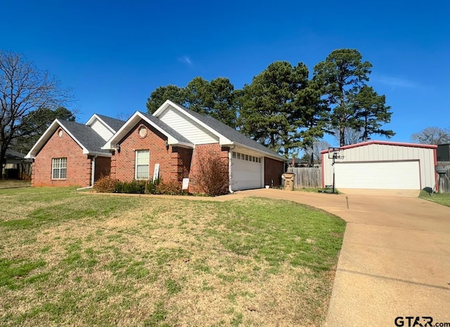 ranch-style home with a garage and a front lawn