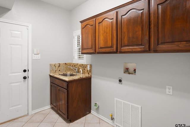 laundry area with sink, cabinets, washer hookup, electric dryer hookup, and light tile patterned floors