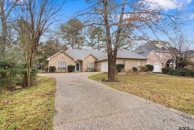 ranch-style house featuring a front lawn and a garage