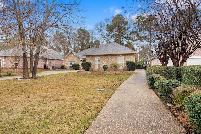 ranch-style home with a front lawn