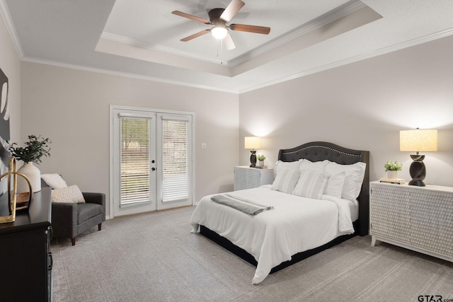 bedroom featuring french doors, ceiling fan, access to exterior, ornamental molding, and a tray ceiling