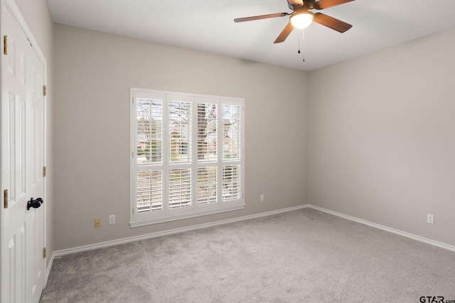 unfurnished room featuring ceiling fan and light colored carpet