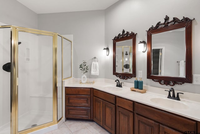 bathroom with tile patterned floors, vanity, and a shower with shower door