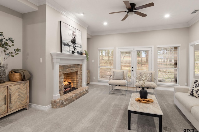 carpeted living room featuring french doors, a brick fireplace, ceiling fan, and ornamental molding