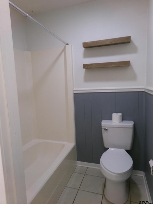 803 Corey, Whitehouse, TX 75791 - bathroom featuring tile patterned flooring, toilet, a wainscoted wall, and bathtub / shower combination