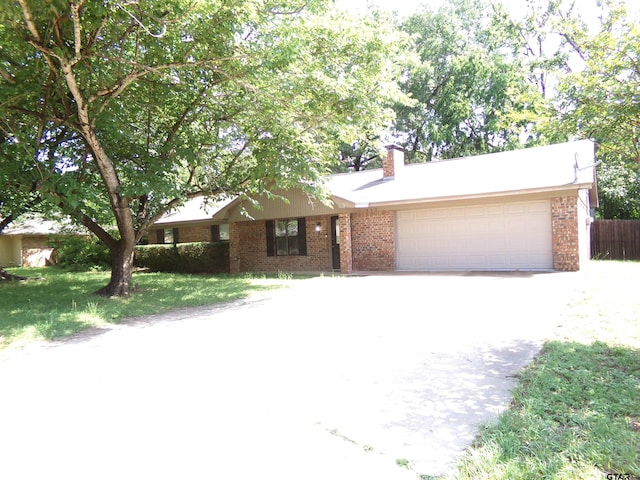 803 Corey, Whitehouse, TX 75791 - single story home with a garage, brick siding, concrete driveway, and a chimney