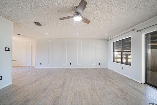 spare room featuring light hardwood / wood-style floors, ceiling fan, a textured ceiling, and crown molding