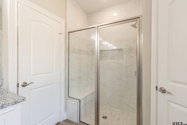 bathroom with a shower with door and wood-type flooring