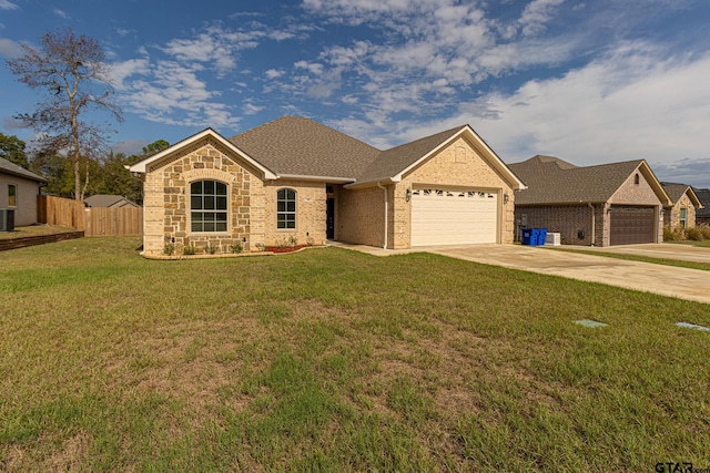 ranch-style home featuring a garage and a front yard