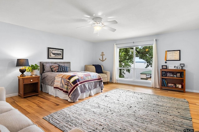 21028 Bay Shore Dr, Flint, TX 75762 - bedroom with light wood finished floors and ceiling fan
