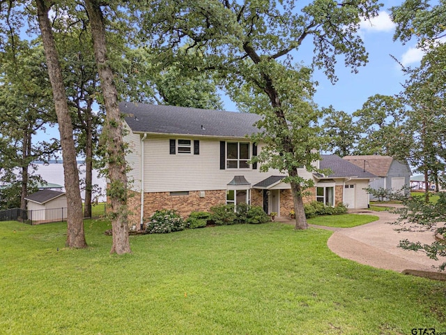 21028 Bay Shore Dr, Flint, TX 75762 - view of front of house with driveway, a shingled roof, and a garage