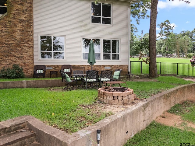 21028 Bay Shore Dr, Flint, TX 75762 - rear view of house featuring an outdoor fire pit and brick siding