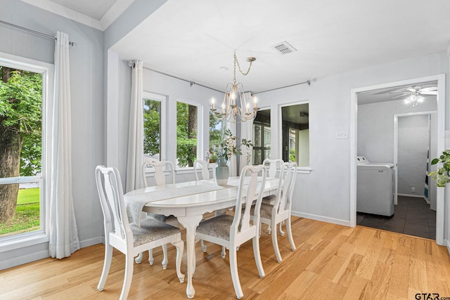 21028 Bay Shore Dr, Flint, TX 75762 - dining space with washer / clothes dryer, a chandelier, light wood-style floors, and a ceiling fan