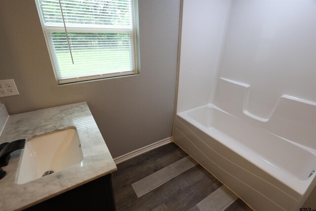 199 Linda Dr, Jefferson, TX 75657 - full bath featuring vanity, wood finished floors, baseboards, and shower / bathtub combination