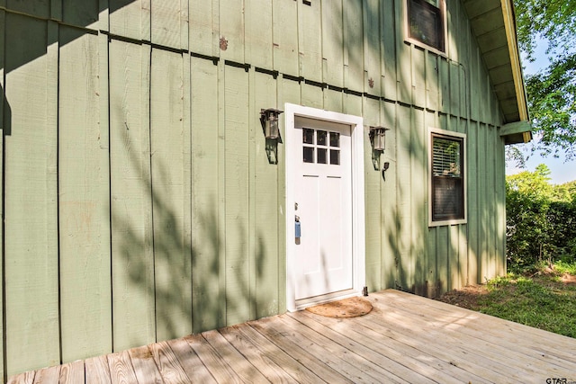 view of exterior entry featuring a deck