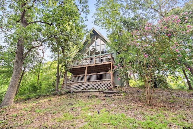 rear view of property featuring a wooden deck