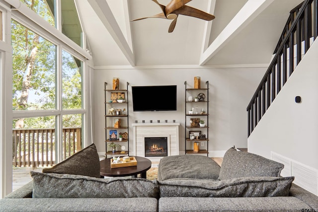 living room featuring high vaulted ceiling, ceiling fan, and beam ceiling