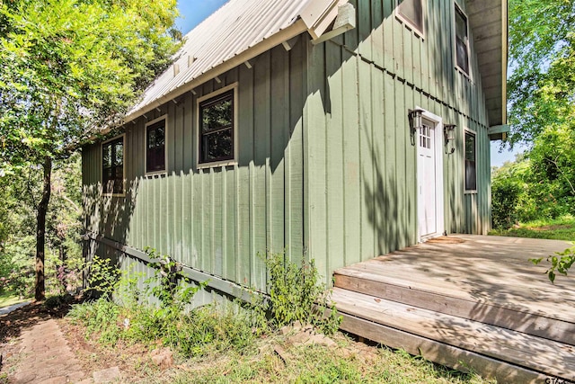 view of property exterior with a wooden deck