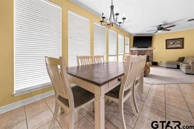 dining room featuring light tile patterned floors and ceiling fan with notable chandelier