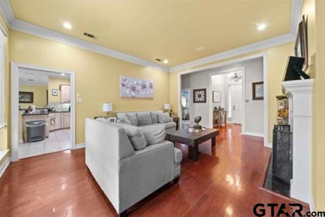 living room featuring crown molding and dark wood-type flooring