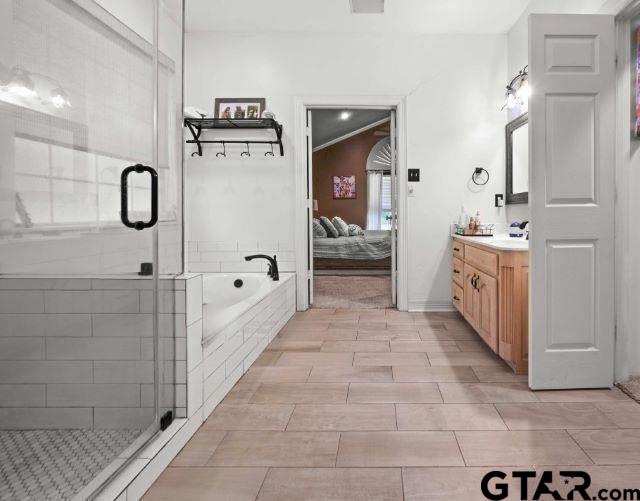 bathroom featuring vanity and plus walk in shower