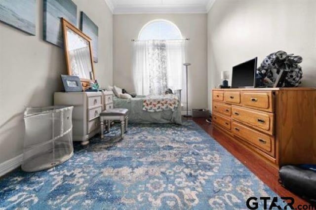 bedroom featuring ornamental molding and dark hardwood / wood-style floors