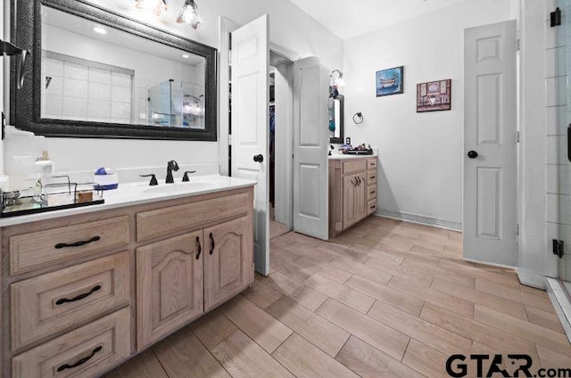 bathroom with vanity and a shower with shower door