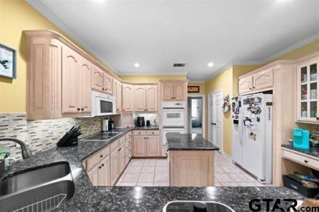 kitchen featuring sink, light tile patterned floors, light brown cabinets, white appliances, and decorative backsplash