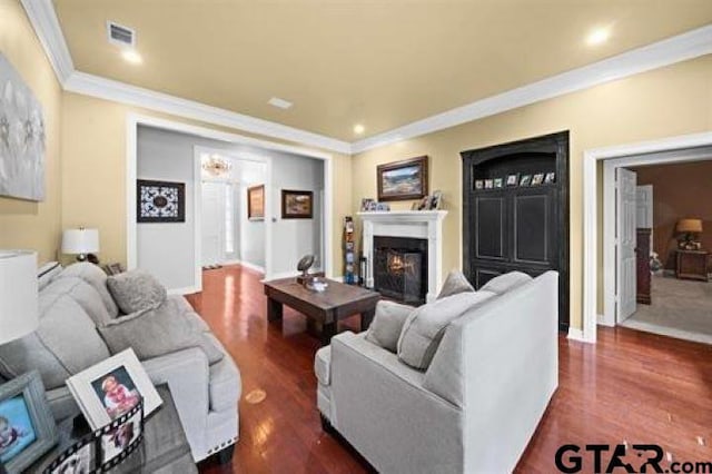 living room featuring dark wood-type flooring and ornamental molding