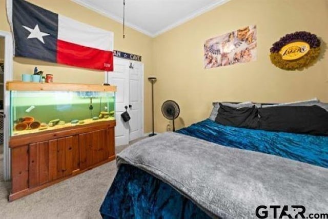 bedroom featuring crown molding and light colored carpet