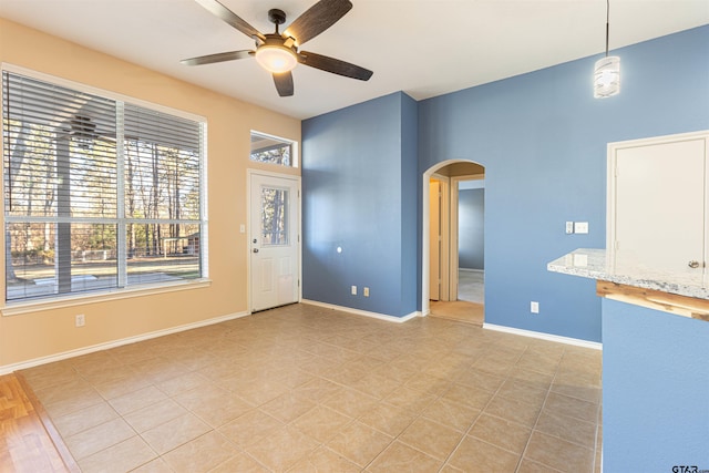 interior space with ceiling fan