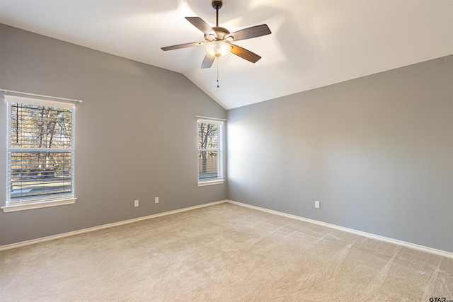 empty room featuring light carpet, ceiling fan, and lofted ceiling